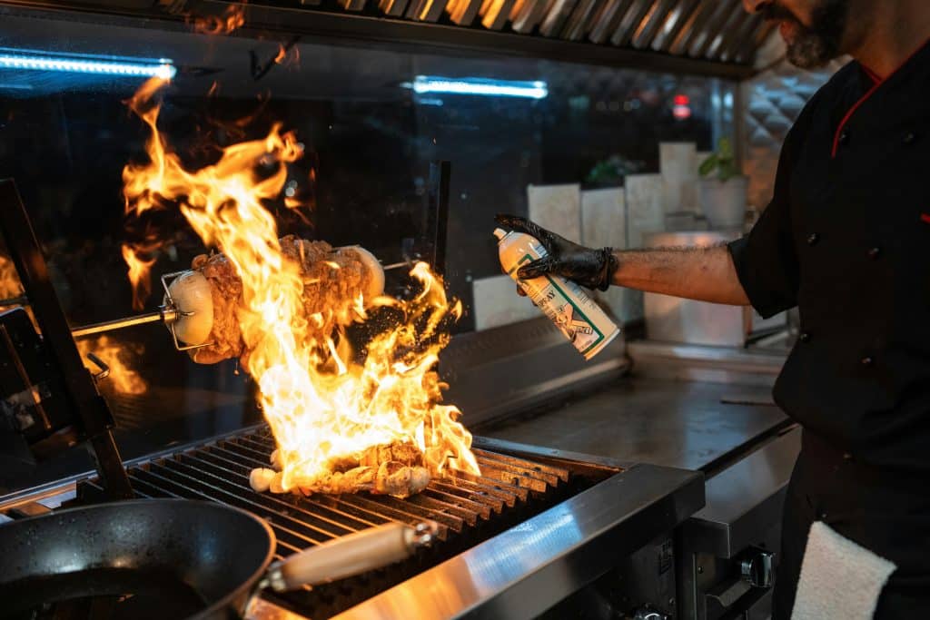 A Person Cooking on the Grill