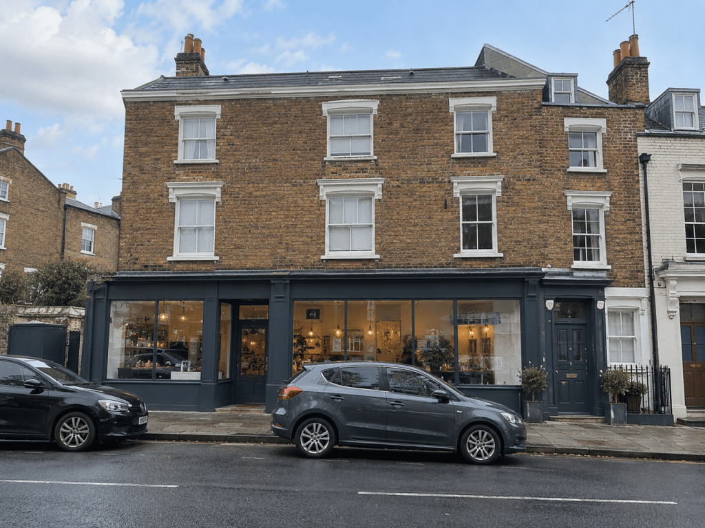 Multi-use brick building with a ground-floor commercial unit and residential accommodation on the upper floors.
